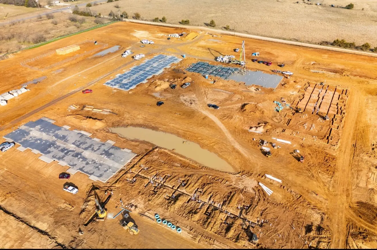 Aerial view of foundation work and civil construction activity across a large site